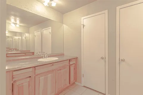 a bathroom with a double vanity sink and a mirror