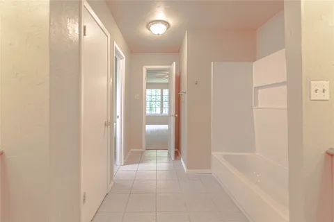 a bathroom with a bathtub and shower