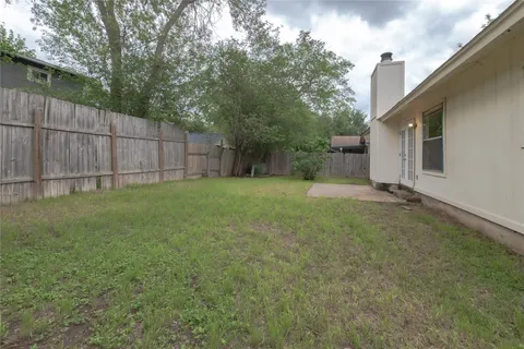a backyard of a house with barbeque oven