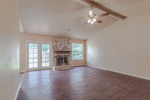 wooden floor in an empty room with a fireplace