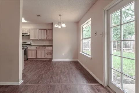 a view of kitchen with wooden floor electronic appliances and windows