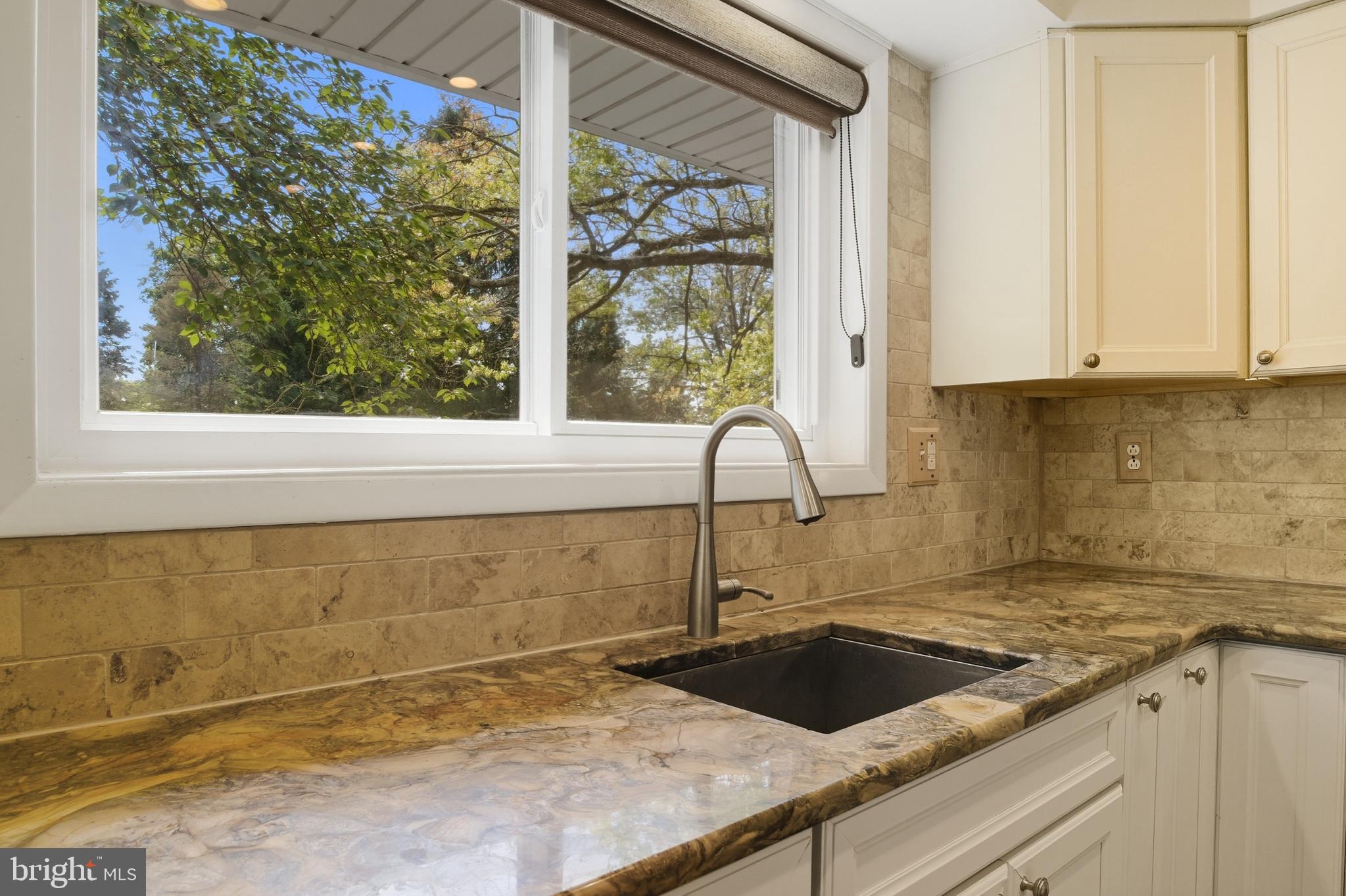 328 Conestoga Road Devon, PA 19333 - Photo 8 of 35 a kitchen with granite countertop a sink and a window
