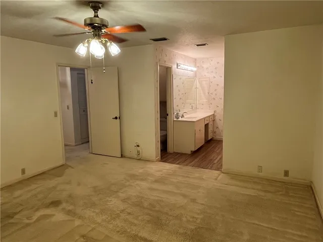 a view of bathroom with a shower and a door