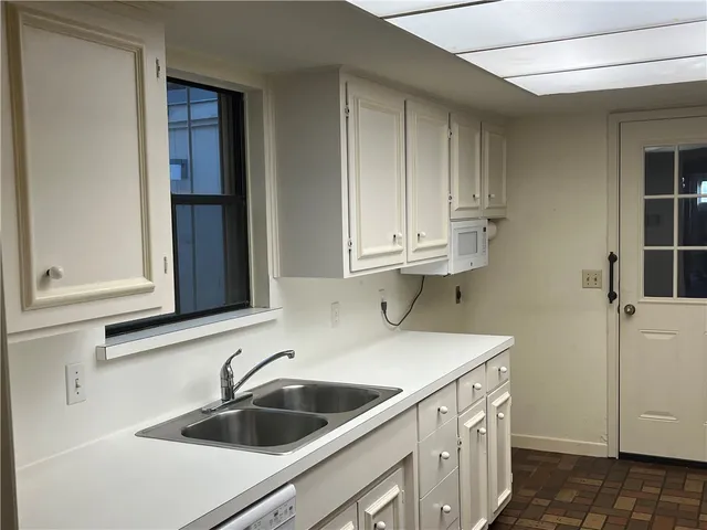 a bathroom with a granite countertop sink and mirror