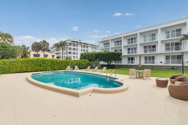 a view of a swimming pool with a garden and plants