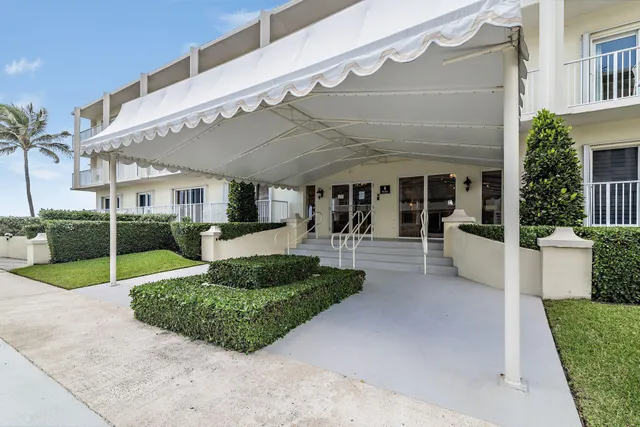 a view of a patio with table and chairs