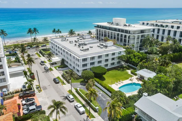 a view of a building with a garden and plants