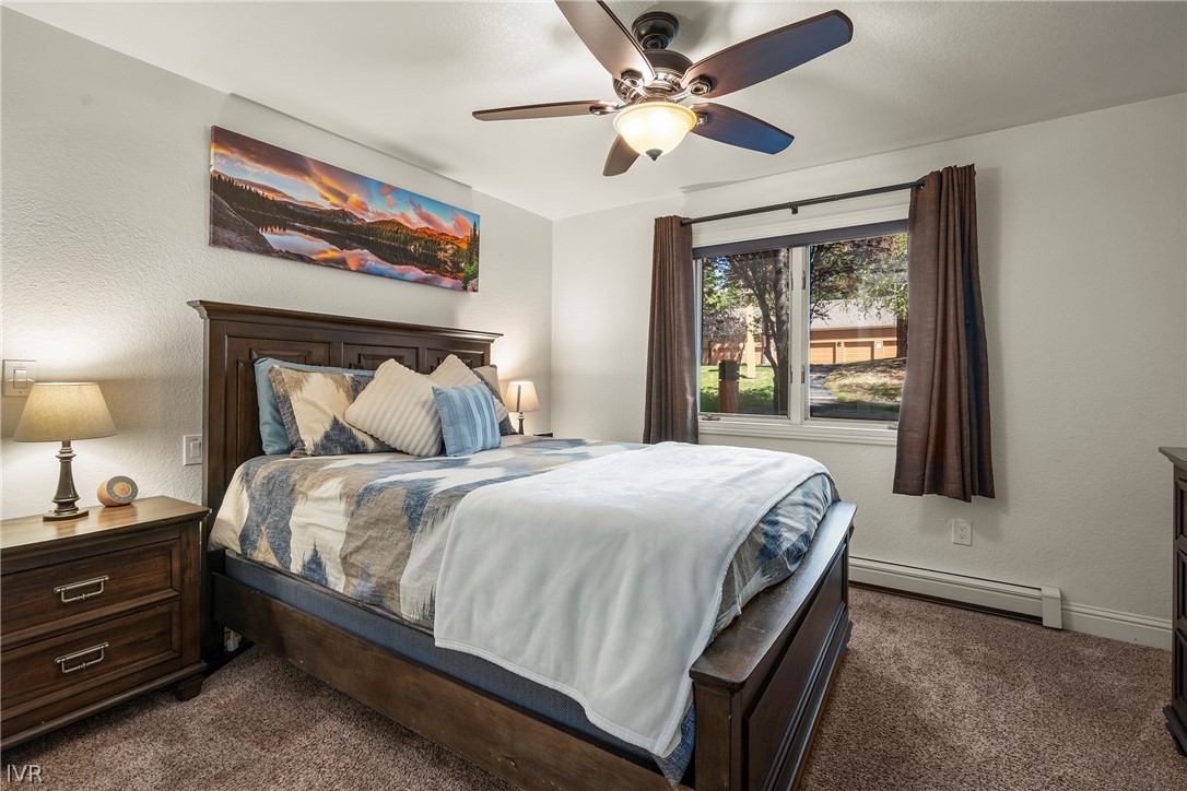939 Incline Way, Unit 200 Incline Village, NV 89451 - Photo 13 of 27 a bedroom with a bed chandelier and a window
