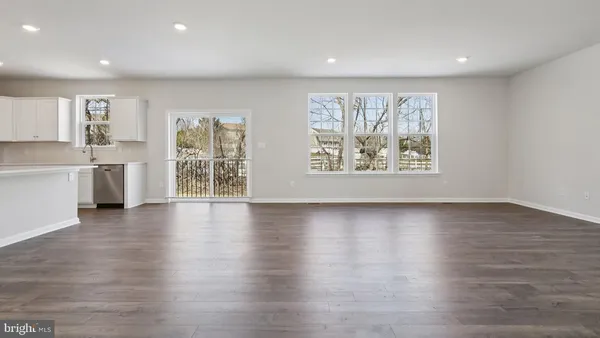 a kitchen with stainless steel appliances granite countertop white cabinets and a stove top oven