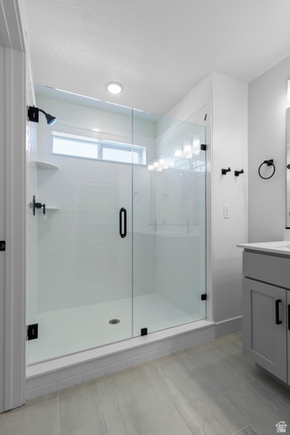 2816 West Aurora Avenue Mapleton, UT 84664 - Photo 10 of 20 Bathroom featuring vanity, a stall shower, and light tile patterned floors