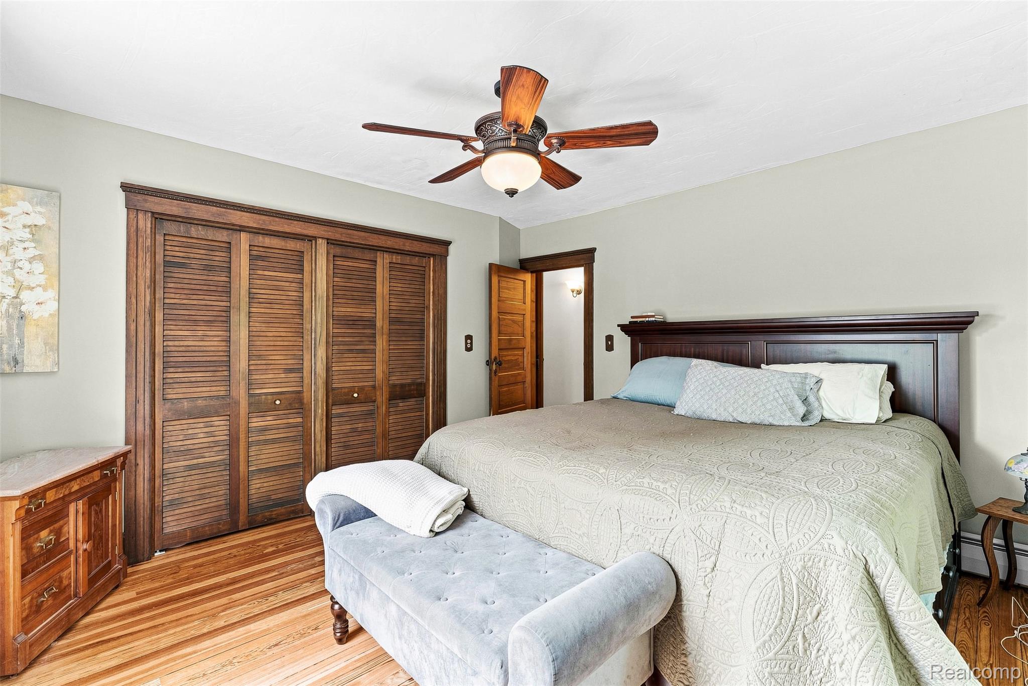 2971 Huron Line Road Cass City, MI 48726 - Photo 32 of 63 Hardwood flooring, wood-finish louvered closet doors, wood-finish ceiling fan, and wood-finish door frames