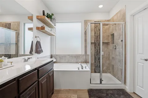 a bathroom with a double vanity sink mirror and shower