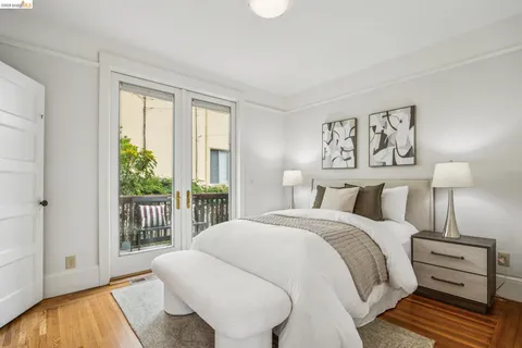 a bedroom with a bed and large window with outer view