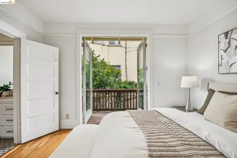 a bedroom with a bed a dresser and mirror