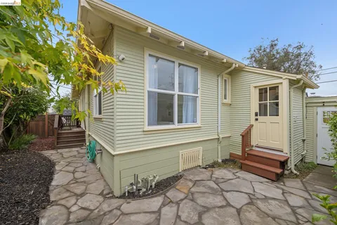 a yellow house with trees in front of it