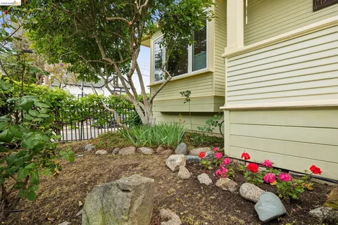 a flower garden is sitting in front of a house