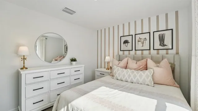 a bedroom with a large bed and a dresser