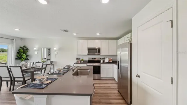 a view of a dining room kitchen and stainless steel appliances