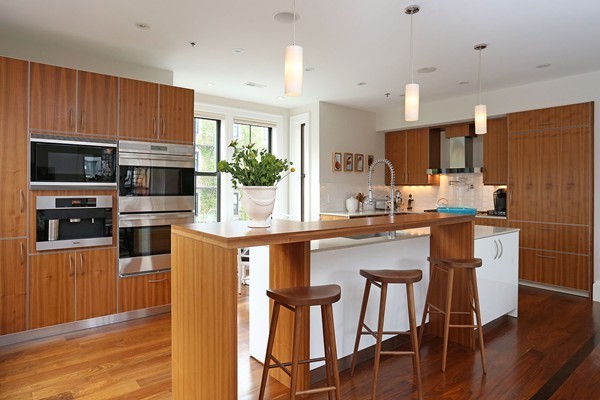 32 Rutland Street, Unit 2L Boston, MA 02118 - Photo 7 of 22 a kitchen with stainless steel appliances wooden floor dining table and chairs