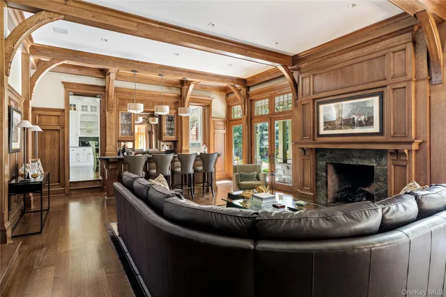 a living room with fireplace furniture and a large window