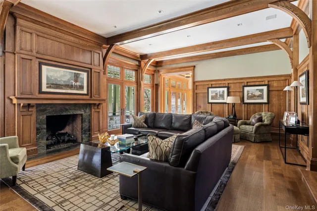 a view of a hallway with wooden floor and chandelier