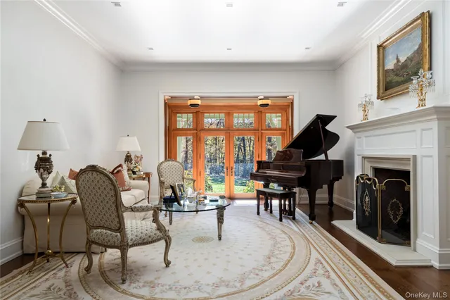 a living room with furniture a large window and a flat screen tv
