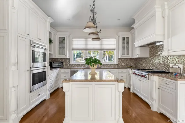 a bathroom with double sink and a window