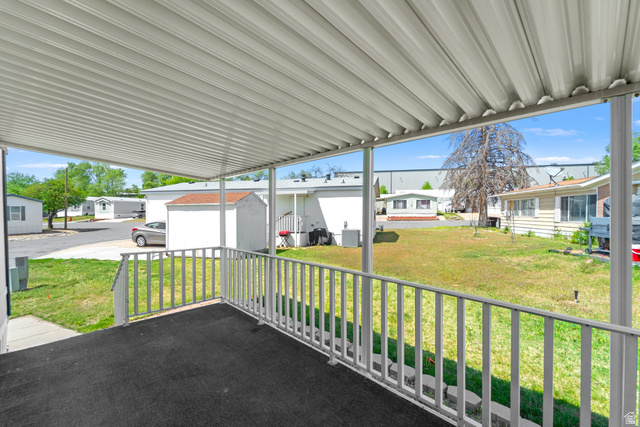 2600 North Hill Field Road, Unit 103A Layton, UT 84041 - Photo 2 of 31 Covered porch with a textured dark gray floor and white railing