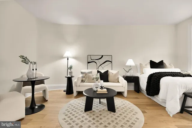 a living room with furniture a rug and a table