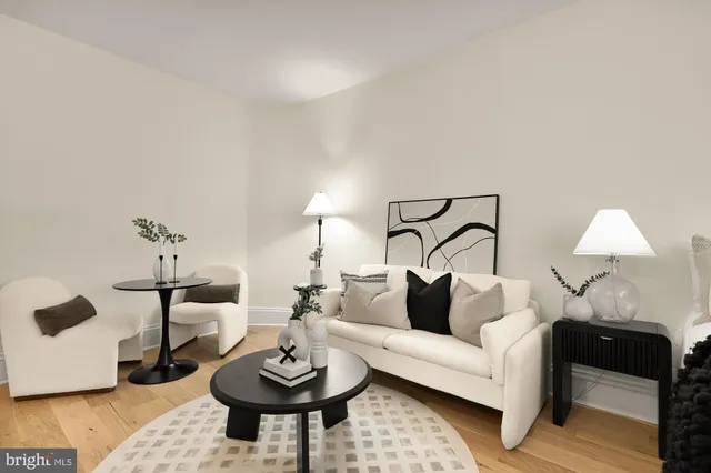 a living room with furniture and a lamp