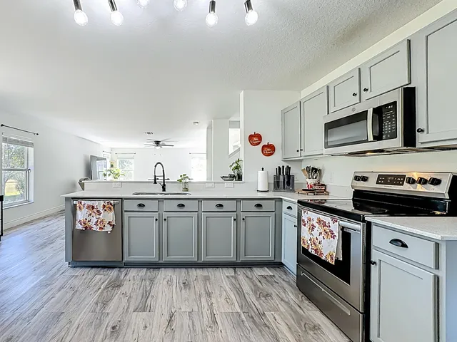 a kitchen with stainless steel appliances a refrigerator sink and cabinets