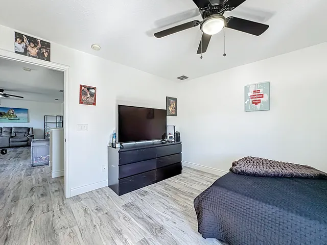 a bed room with a bed and a television