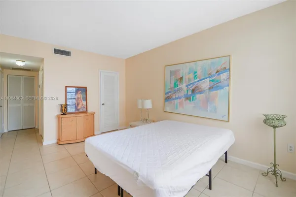 a bedroom with a bed and dresser