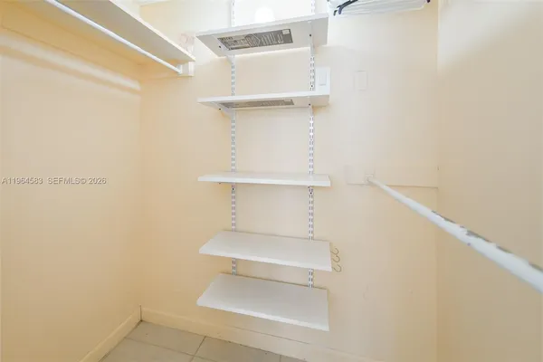 a white toilet sitting next to a white wall