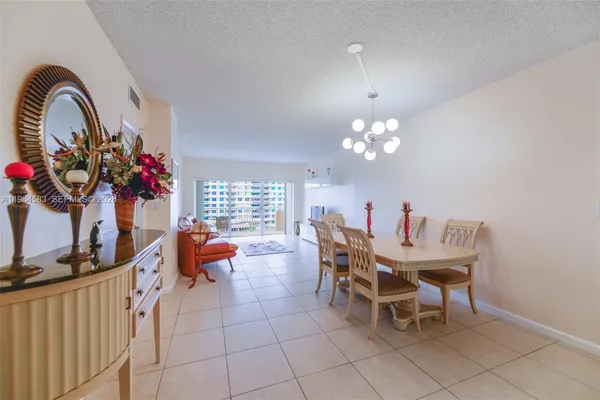 a dining room with furniture and chandelier
