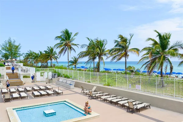 a view of a backyard with a patio and ocean view