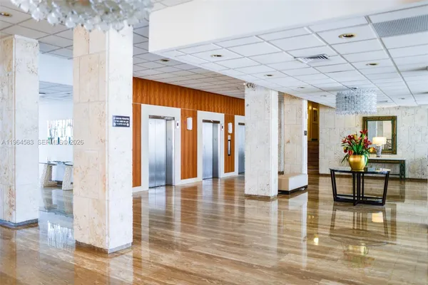 a lobby with furniture and rug