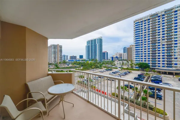 a balcony with city view and sitting space