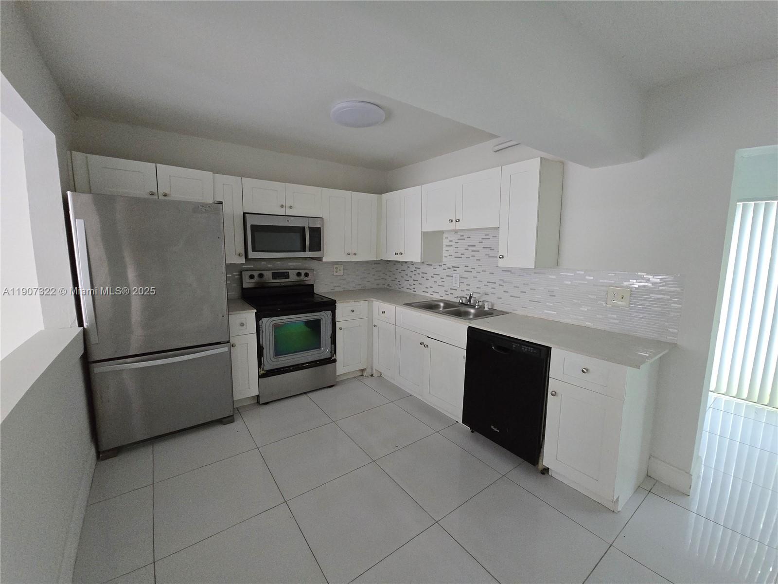 2650 Northwest 60th Way, Unit 176 Sunrise, FL 33313 - Photo 1 of 20 a kitchen with a refrigerator sink and microwave