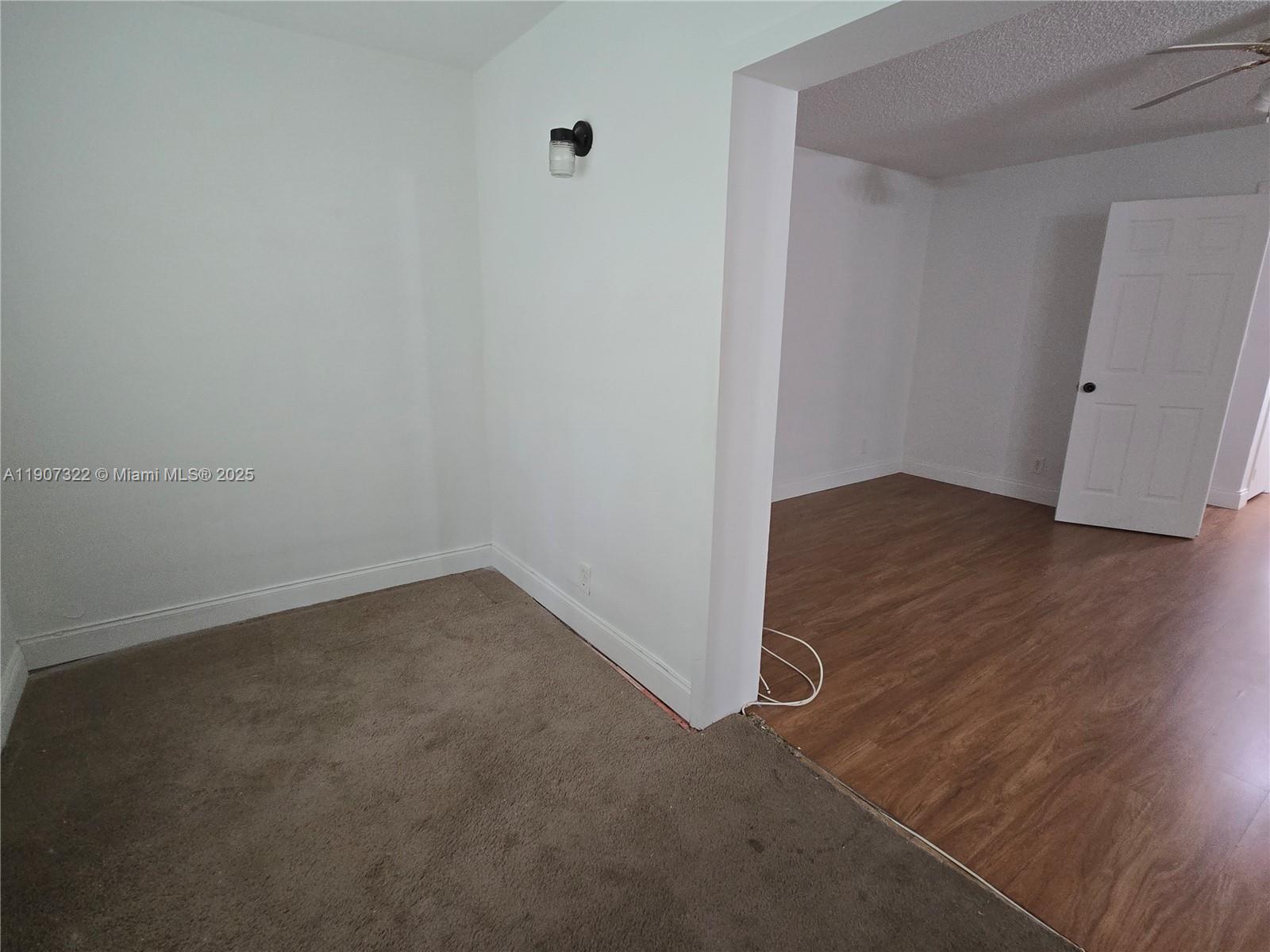 2650 Northwest 60th Way, Unit 176 Sunrise, FL 33313 - Photo 15 of 20 an empty room with wooden floor and windows