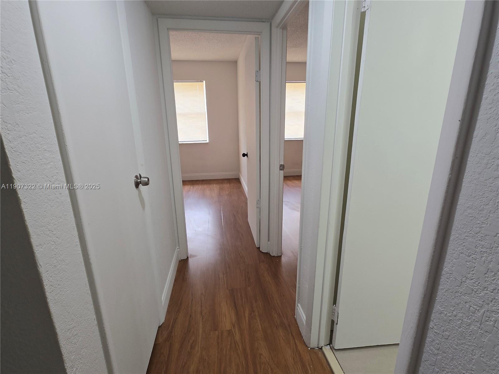 2650 Northwest 60th Way, Unit 176 Sunrise, FL 33313 - Photo 18 of 20 a view of a hallway with wooden floor