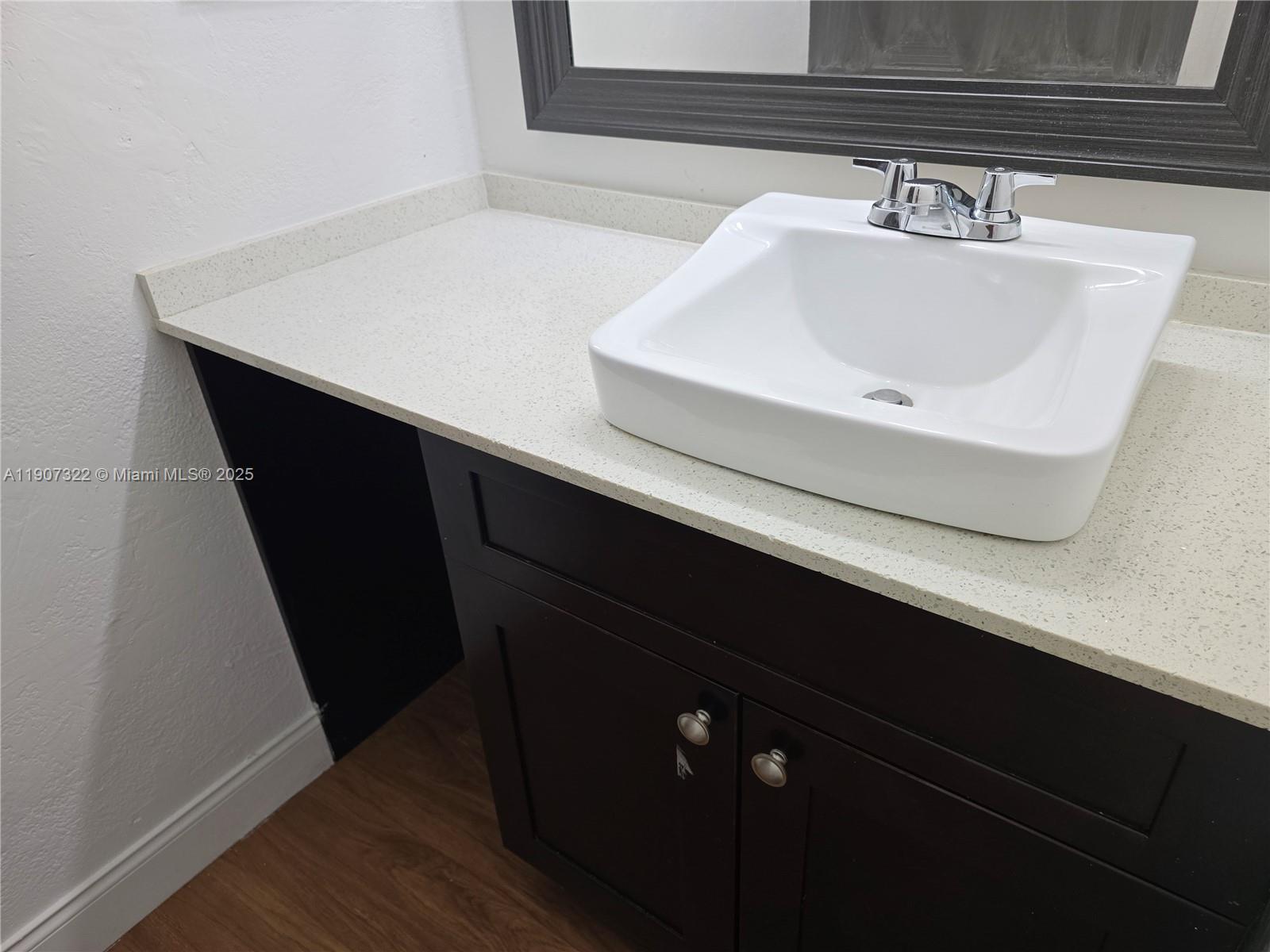 2650 Northwest 60th Way, Unit 176 Sunrise, FL 33313 - Photo 20 of 20 a bathroom with a sink and a mirror
