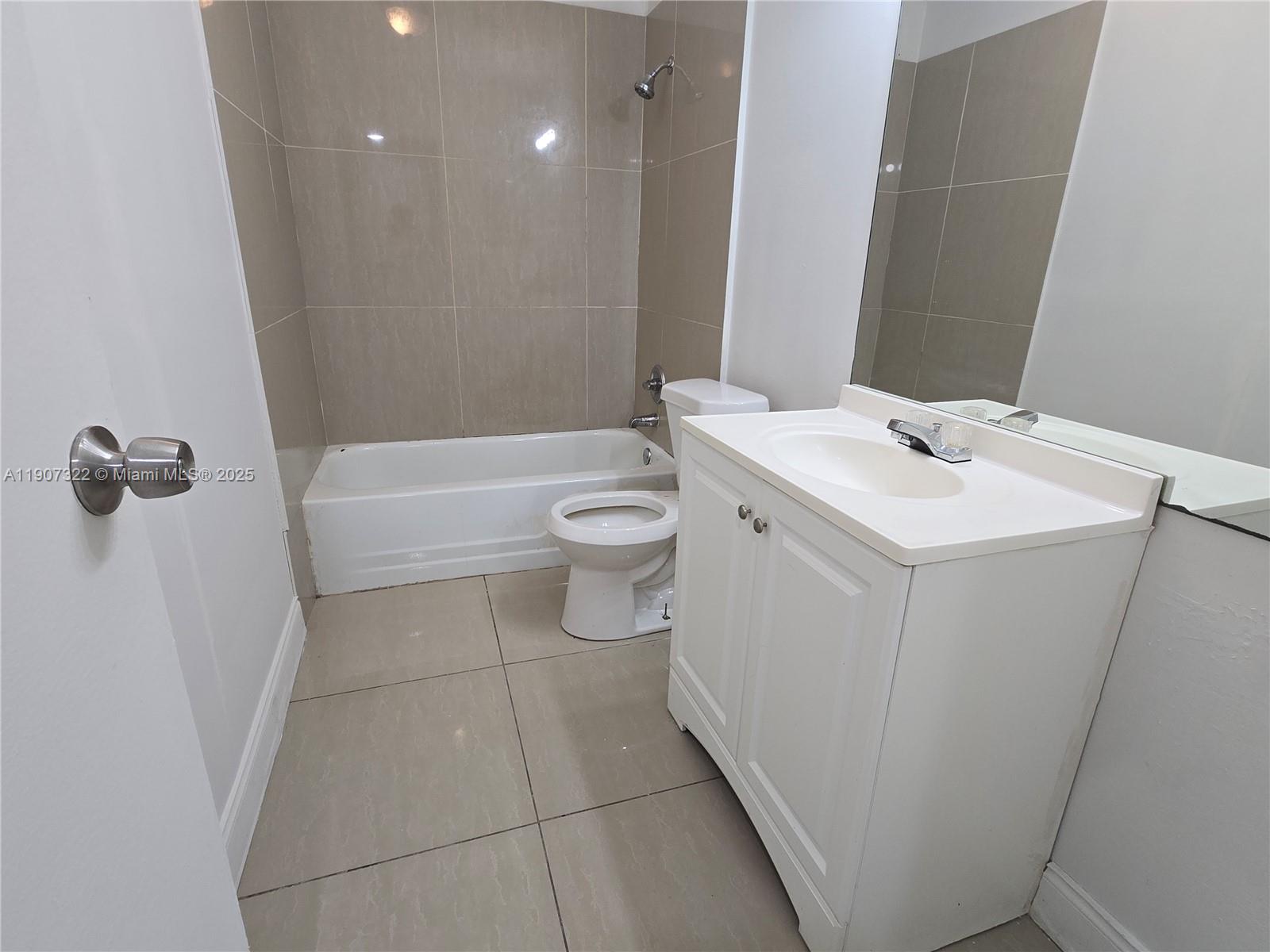 2650 Northwest 60th Way, Unit 176 Sunrise, FL 33313 - Photo 6 of 20 a bathroom with a sink a toilet and shower