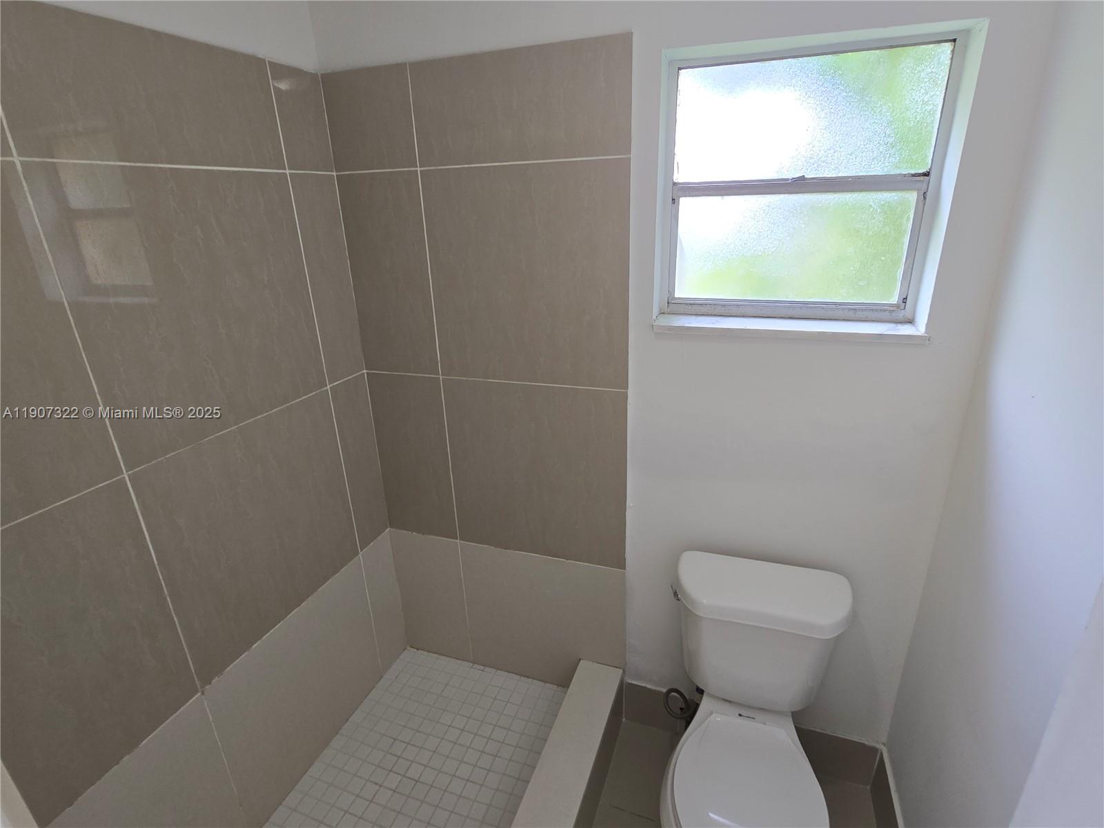 2650 Northwest 60th Way, Unit 176 Sunrise, FL 33313 - Photo 9 of 20 a bathroom with a toilet and a shower