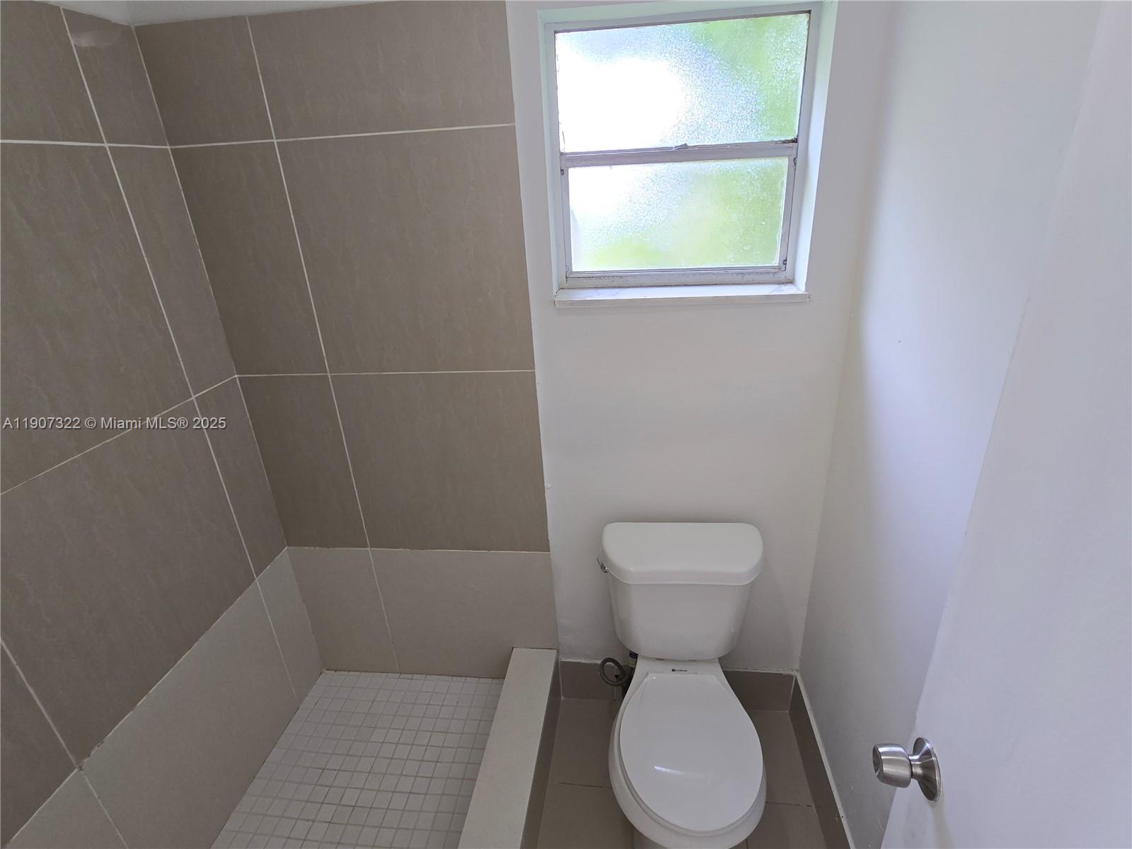 2650 Northwest 60th Way, Unit 176 Sunrise, FL 33313 - Photo 10 of 20 a bathroom with a toilet sink and window