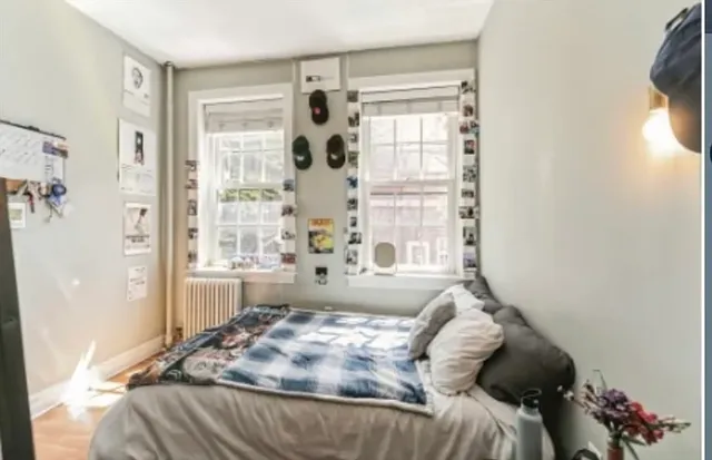 a bedroom with a bed and a window