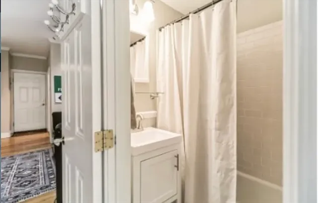 a bathroom with a shower curtain and a sink