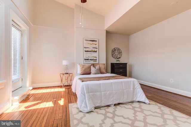 a bedroom with a bed and a window