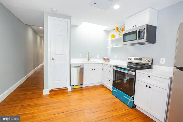 a kitchen that has a sink and a stove in it