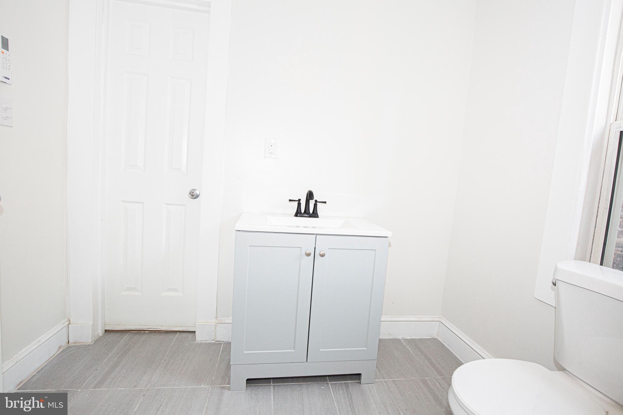 2617 13th Street Northwest Washington, DC 20009 - Photo 8 of 13 a bathroom with a sink a toilet and mirror